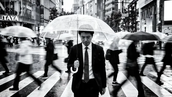 Man In A Suit And Tie Holding An Umbrella
