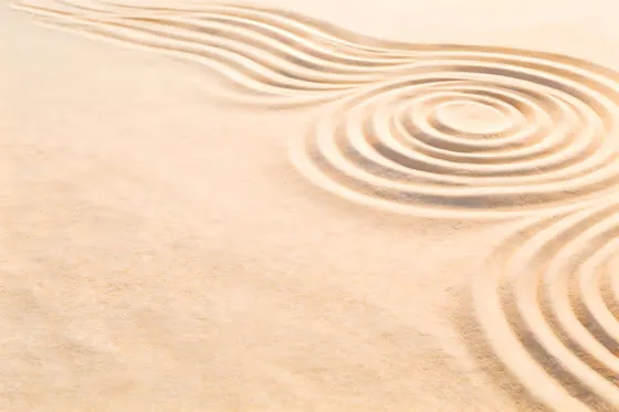Sand Drawing Of A Spiral Design On A Beach
