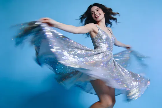 Woman In A Silver Dress Is Dancing